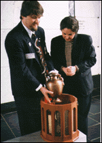 Alan Pickett and Mrs. Mark R. Allen, ex-President of Virginia UDC, place Mrs. Pickett;'s urn in the casket