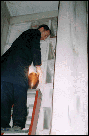 Thomas Hornbaker removes Mrs. Pickett's urn