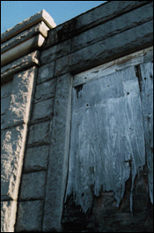 Boarded-over stained-glass window